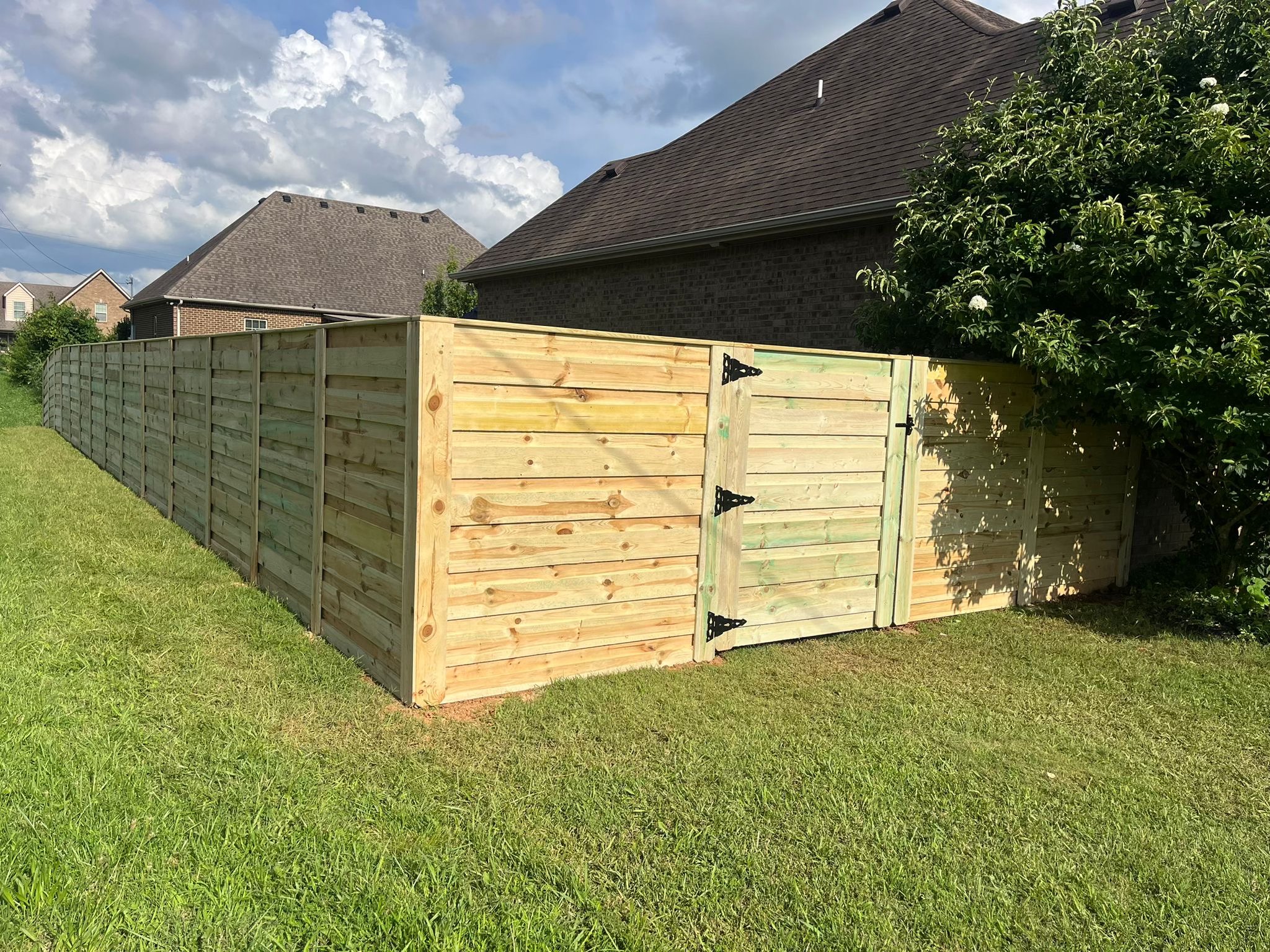Custom horizontal slat wood fence with gate