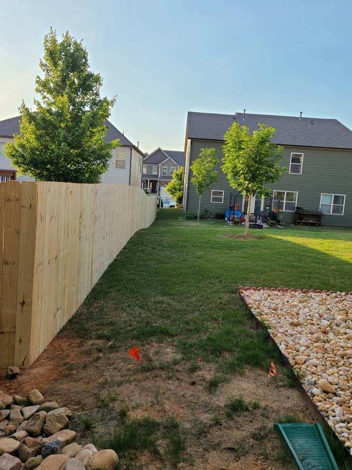 Tall wood privacy fence along property line